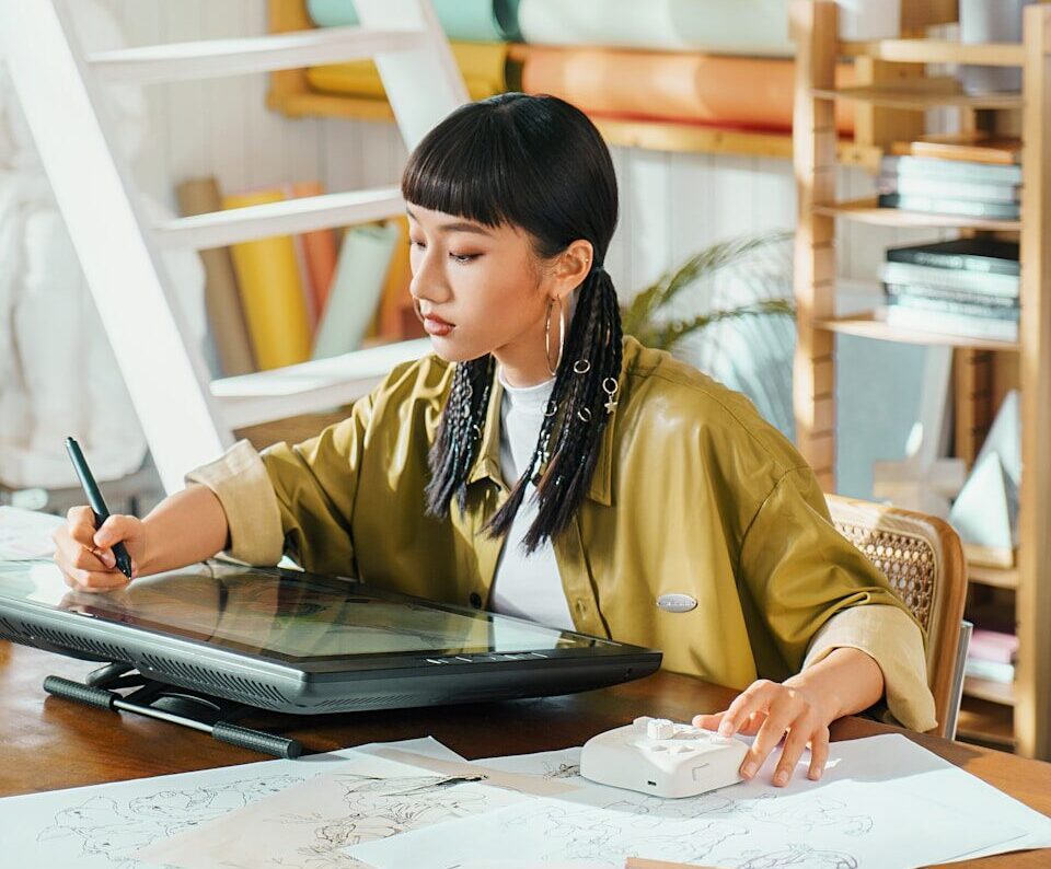 Artist works on a digital tablet in her studio.