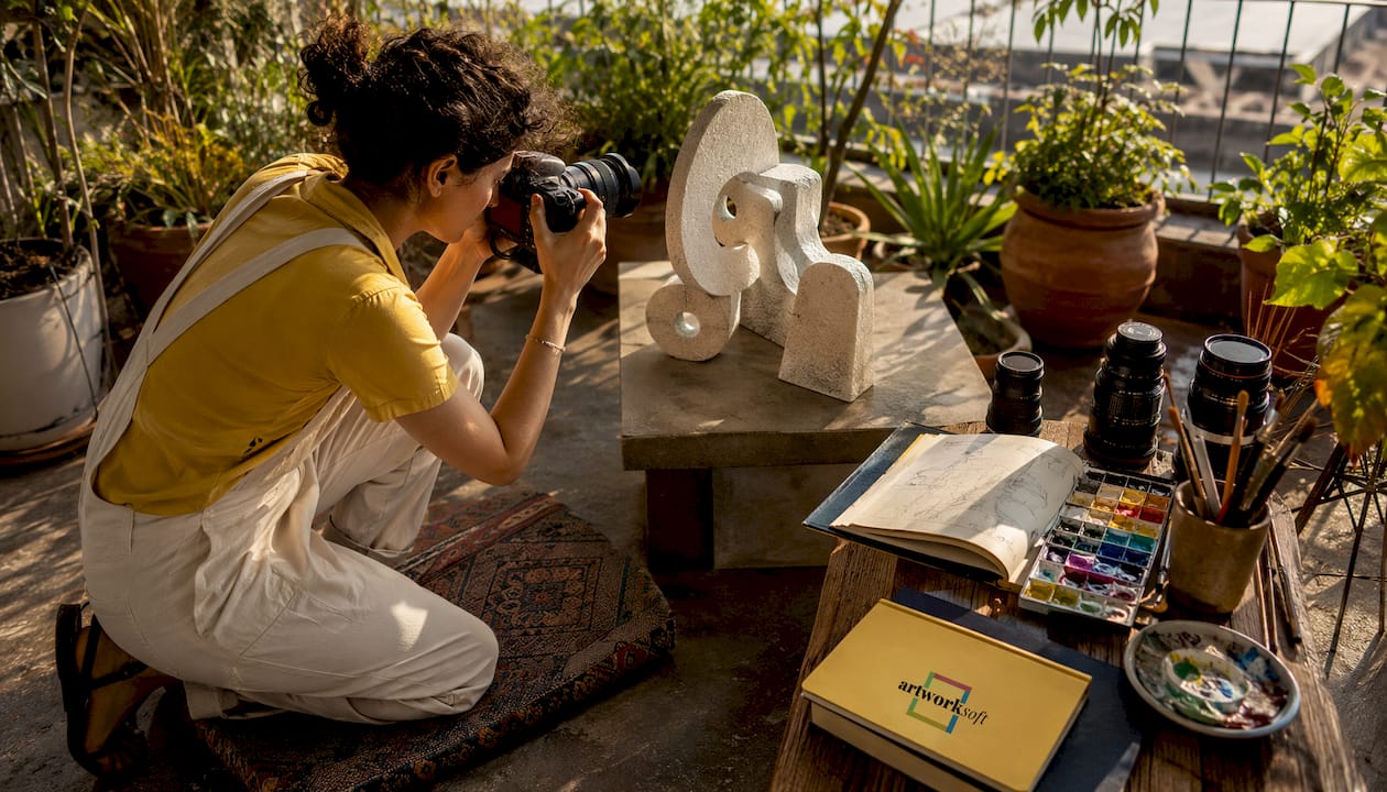 Artist taking detailed photos of sculpture