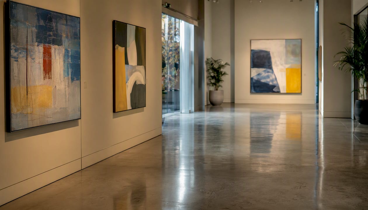 Empty gallery room with iconic blue chip paintings