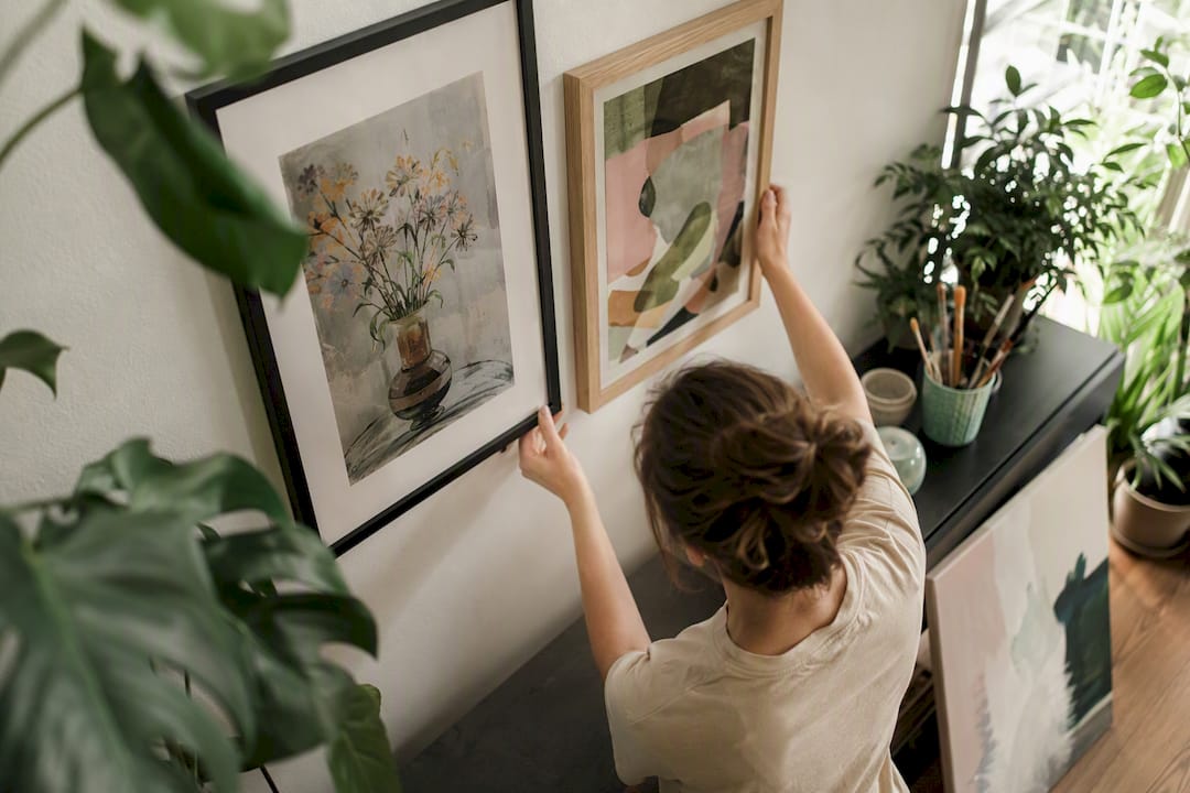 Hands adjusting artwork placement for diversification