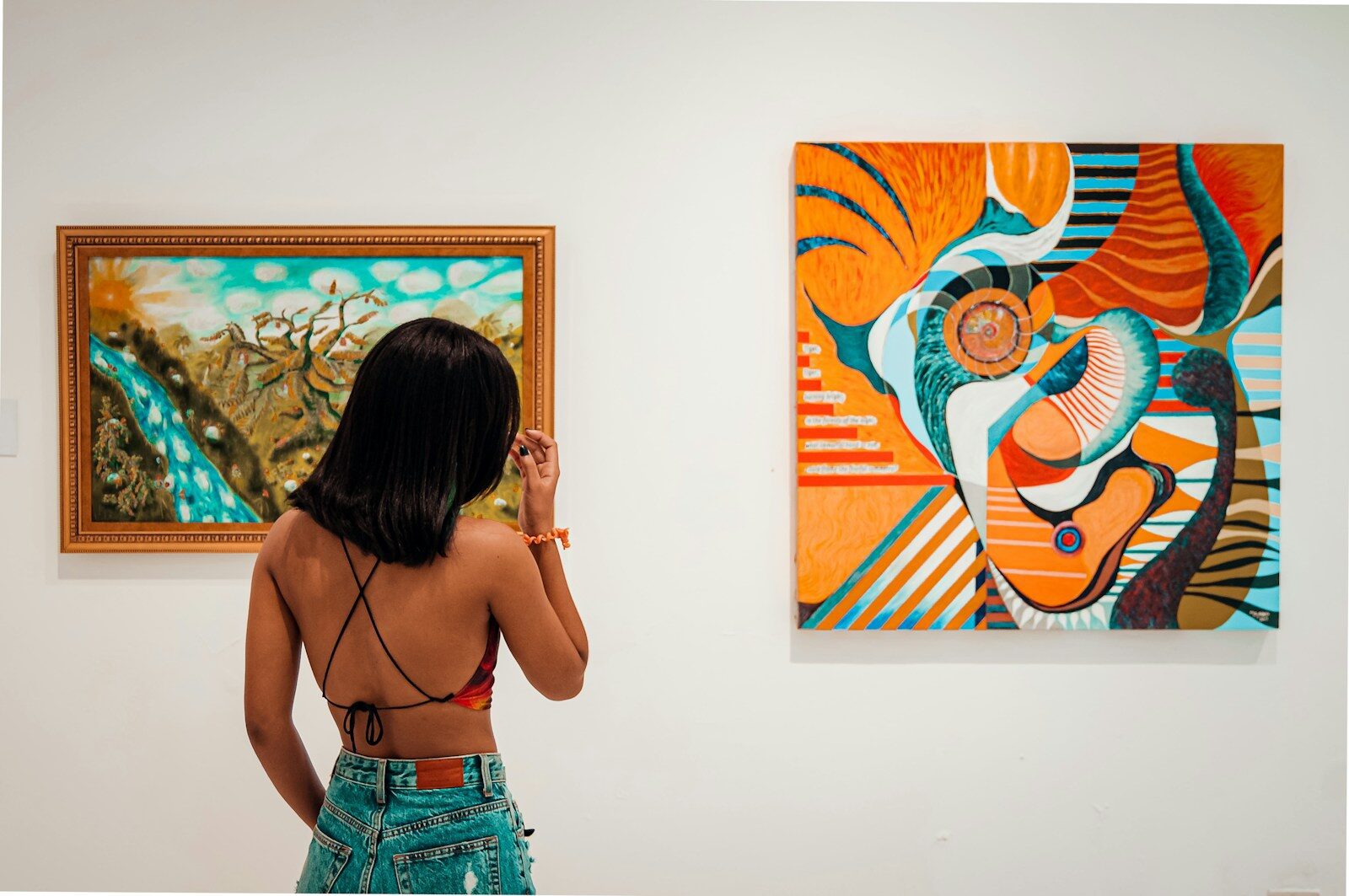 a woman standing in front of two paintings