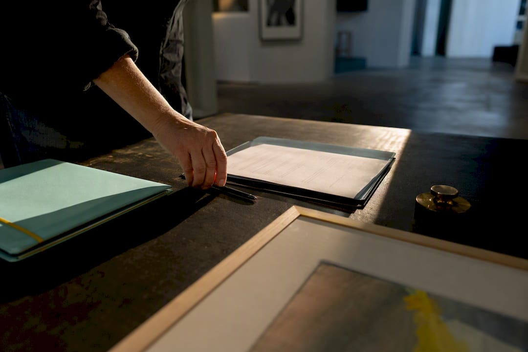Art sale document beside artwork