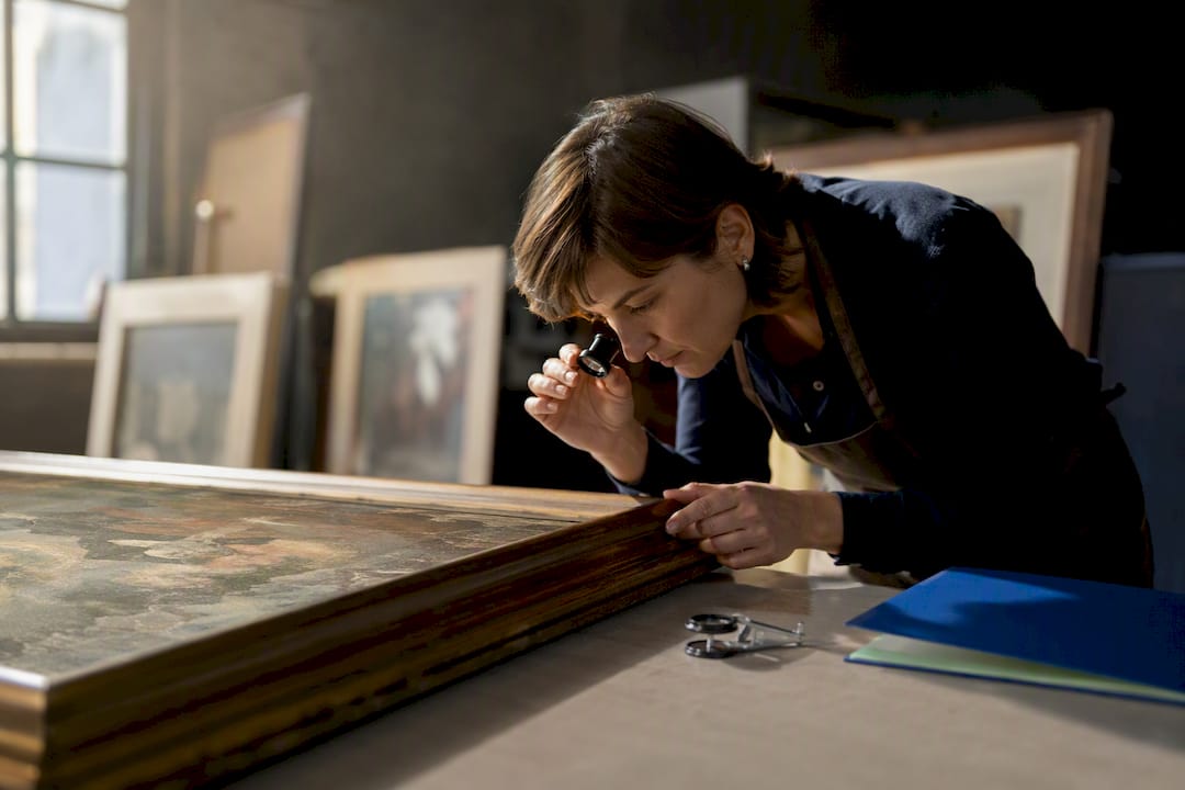 Appraiser inspecting donated artwork