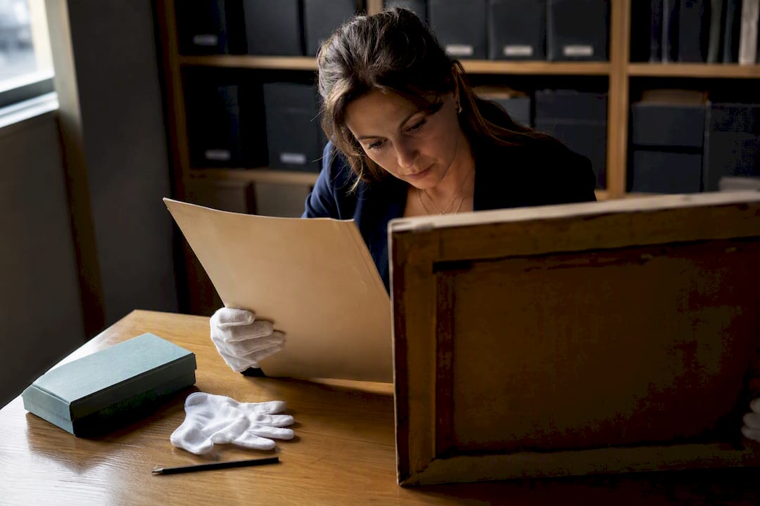 Researcher examining wartime provenance records