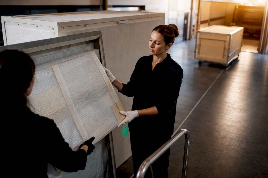 Wrapped artwork being transferred between locations