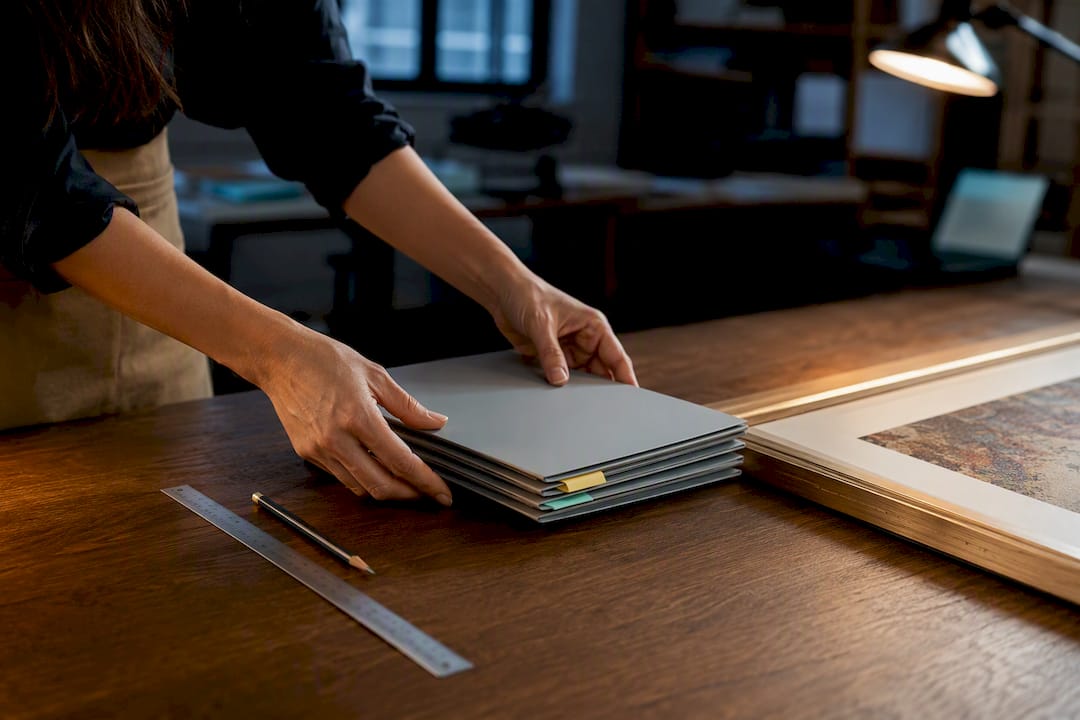 Art registrar preparing collection report folders