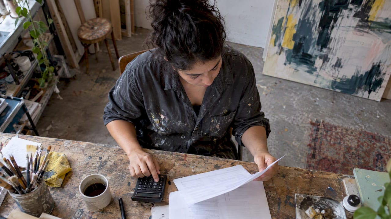 Artist checking gallery invoice before payment